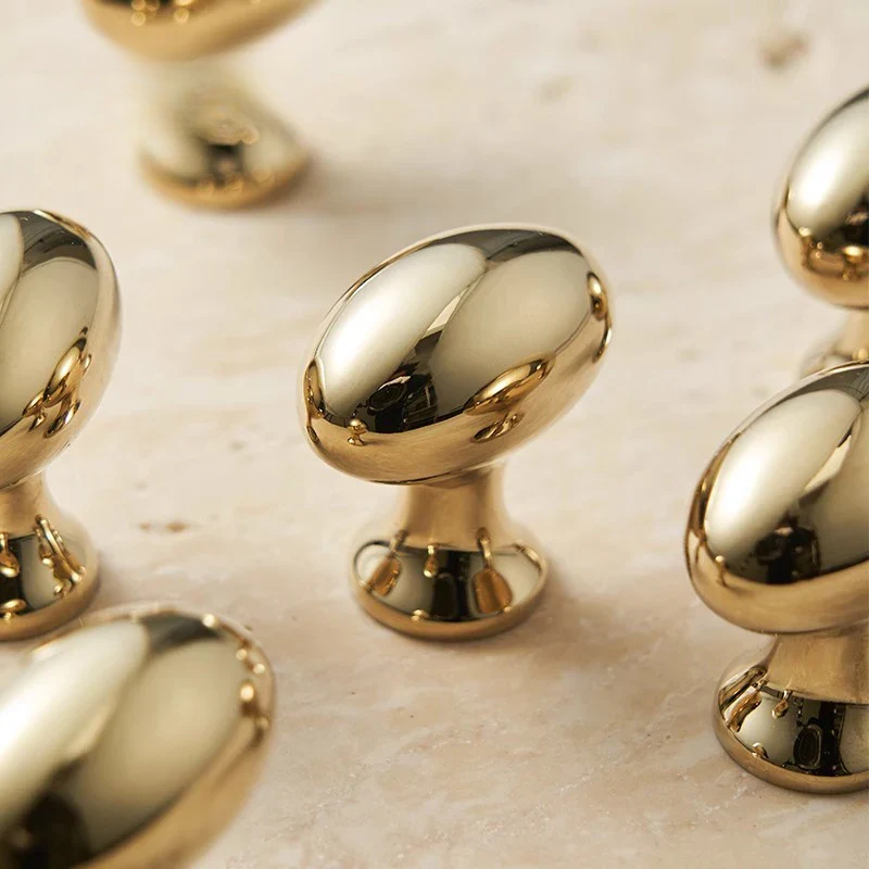 Gold cabinet knobs on a marble surface