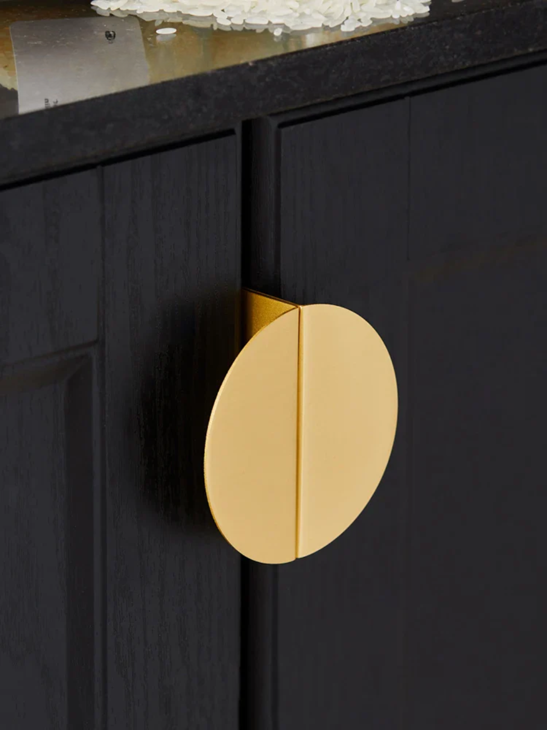 Three gold metal brackets on a gray textured background