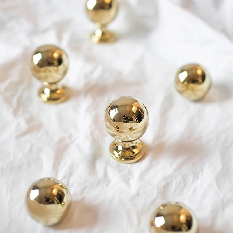 Gold spherical objects on a textured white surface