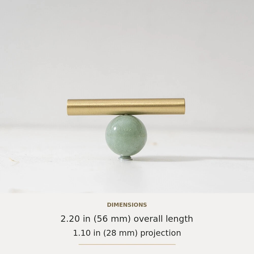 Green decorative accent and brass T-bar cabinet knob