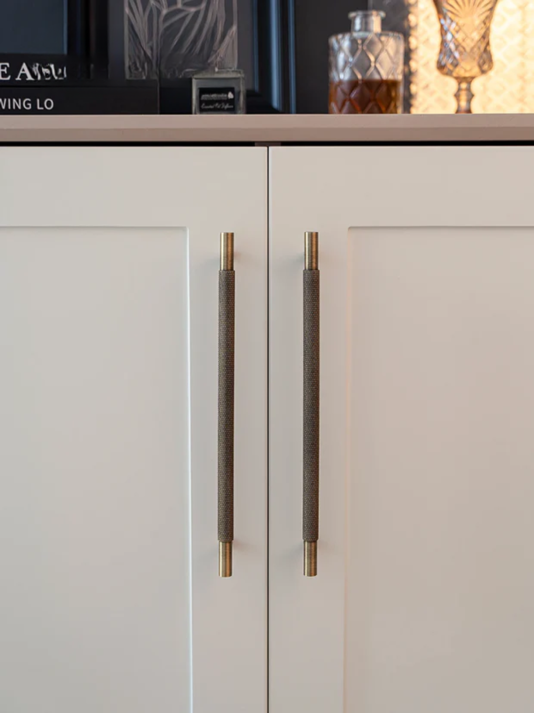 Close-up of a cabinet with decorative handles in a home setting.