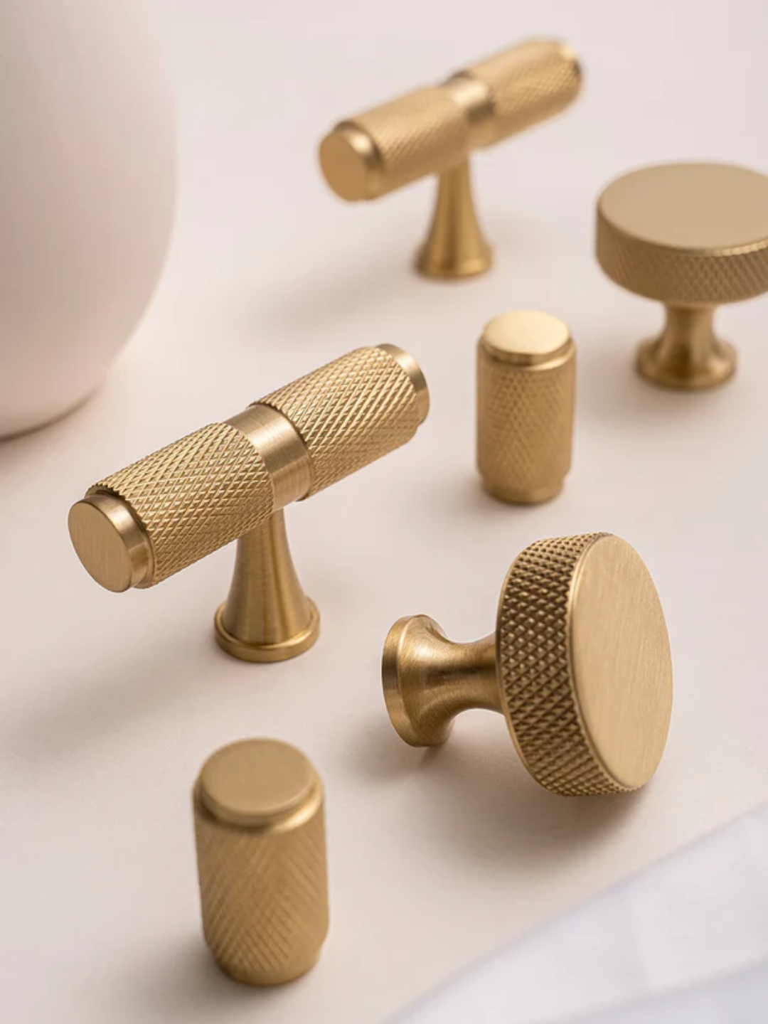 Set of gold cabinet knobs on a light background