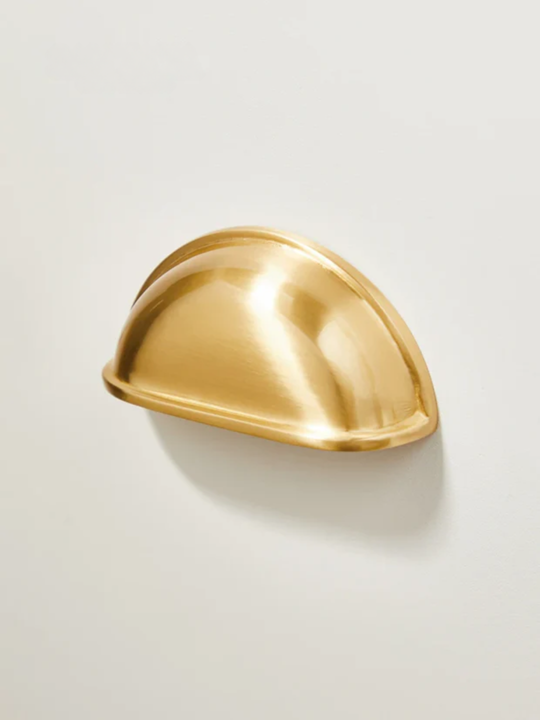 Gold decorative object on a light beige background