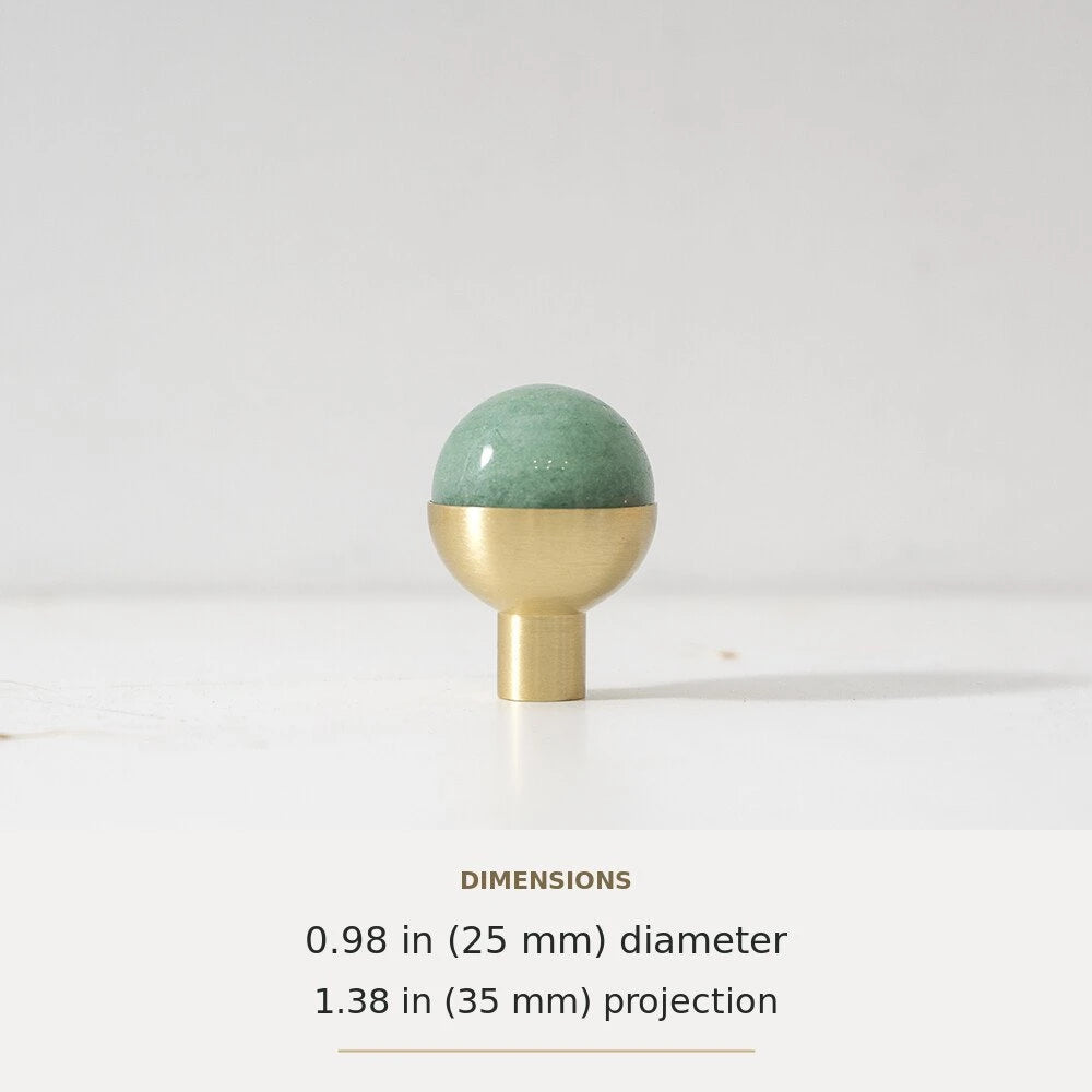 Green decorative accent and brass round cabinet knob