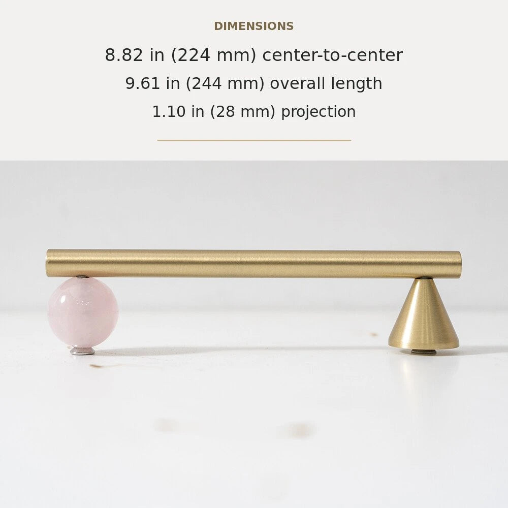 Pink decorative accent and brass cabinet pull, 8.82-inch center-to-center