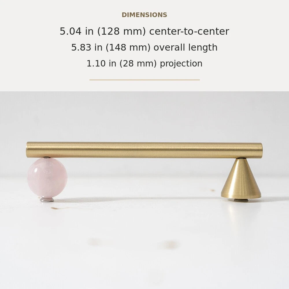 Pink decorative accent and brass cabinet pull, 5.04-inch center-to-center
