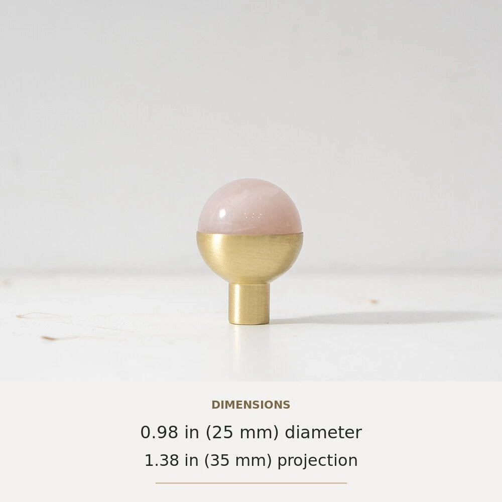 Pink decorative accent and brass round cabinet knob