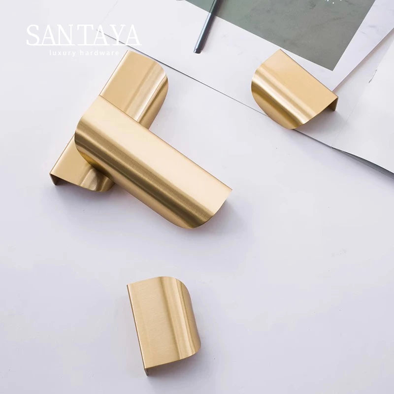 Gold door handles on a white surface with 'SANTAYA' branding.