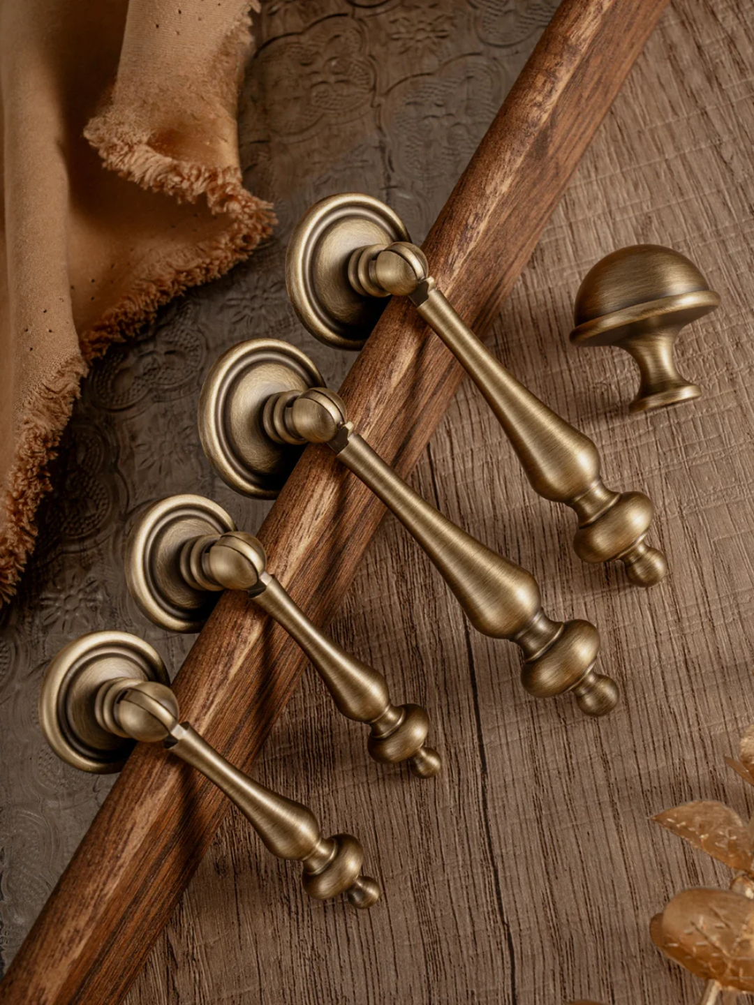 Set of bronze door handles on a wooden surface