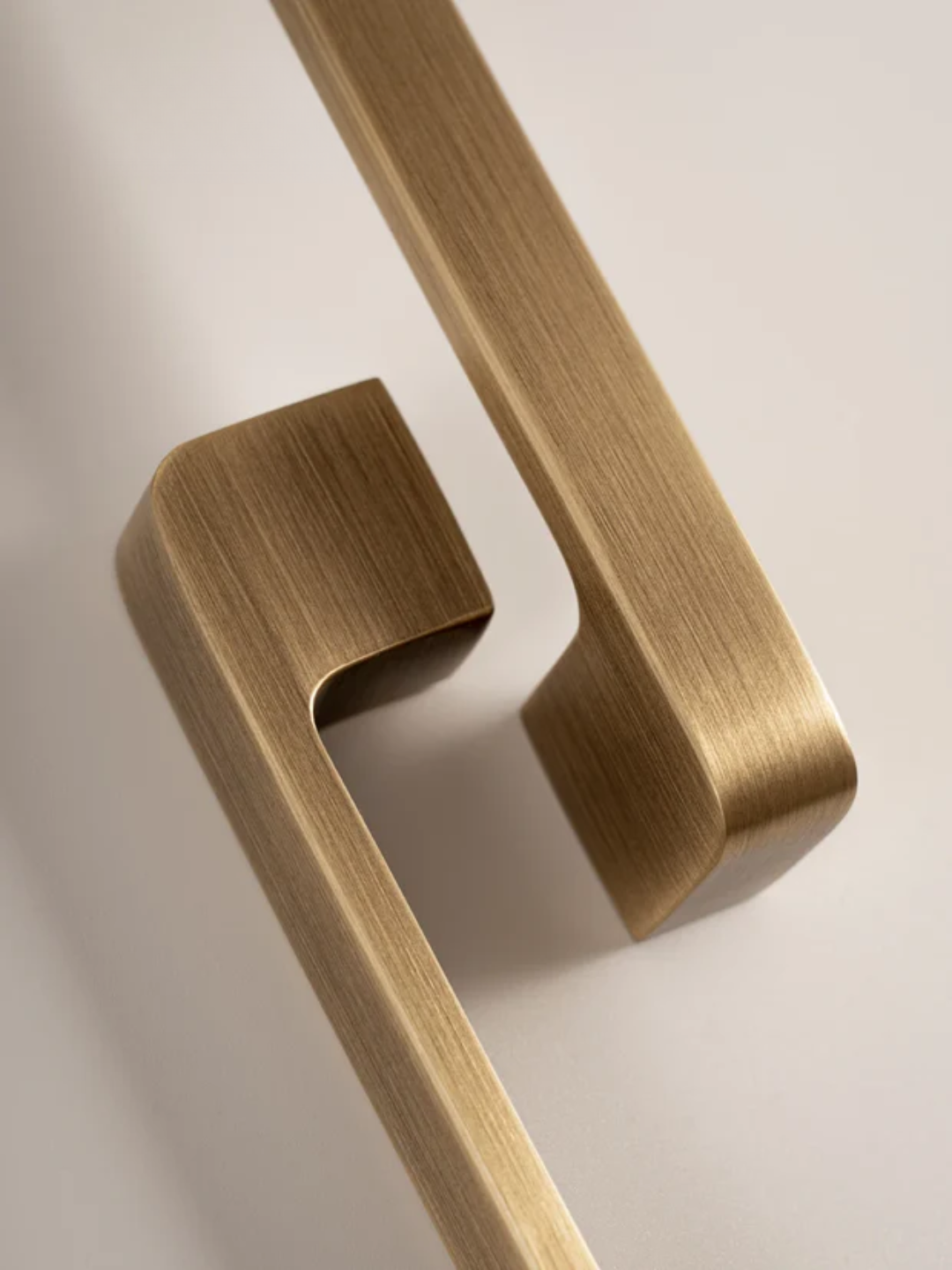 Close-up of a gold door handle on a white background
