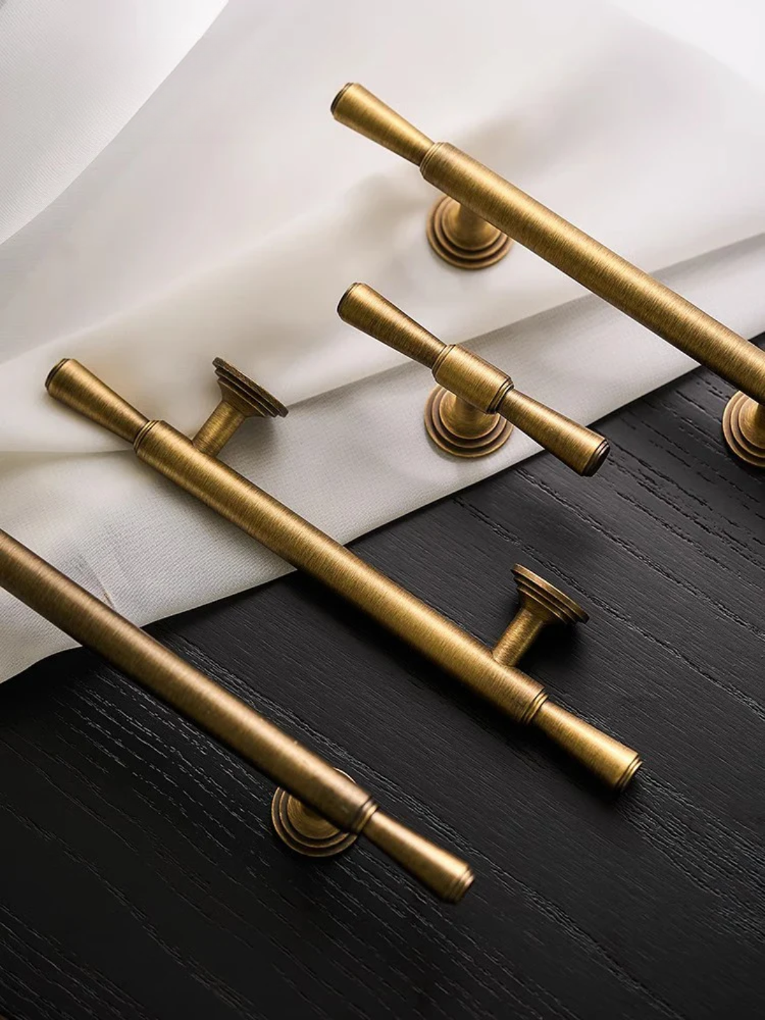 Gold cabinet handles on a black and white background