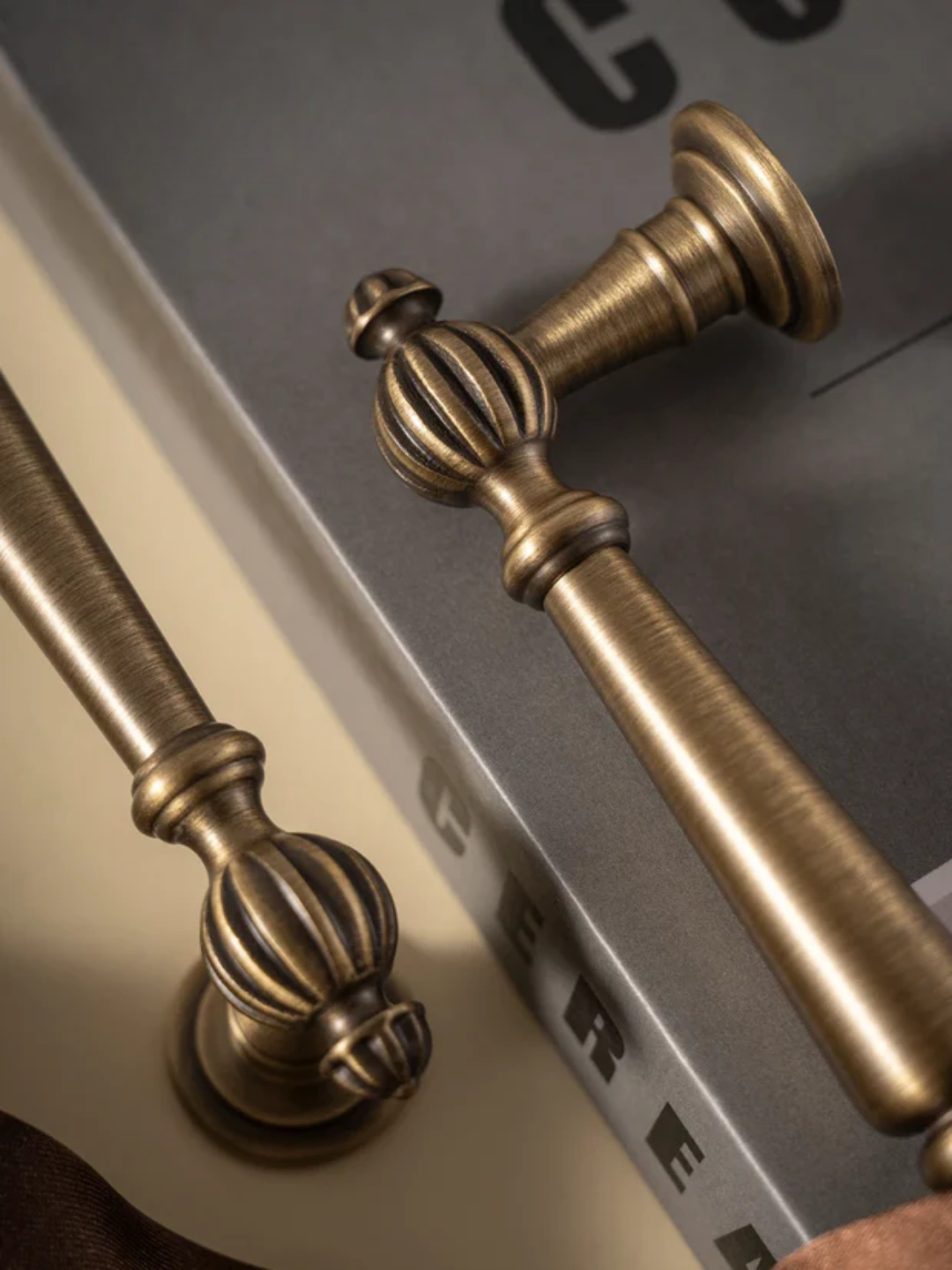 Close-up of ornate bronze handles on a metallic surface