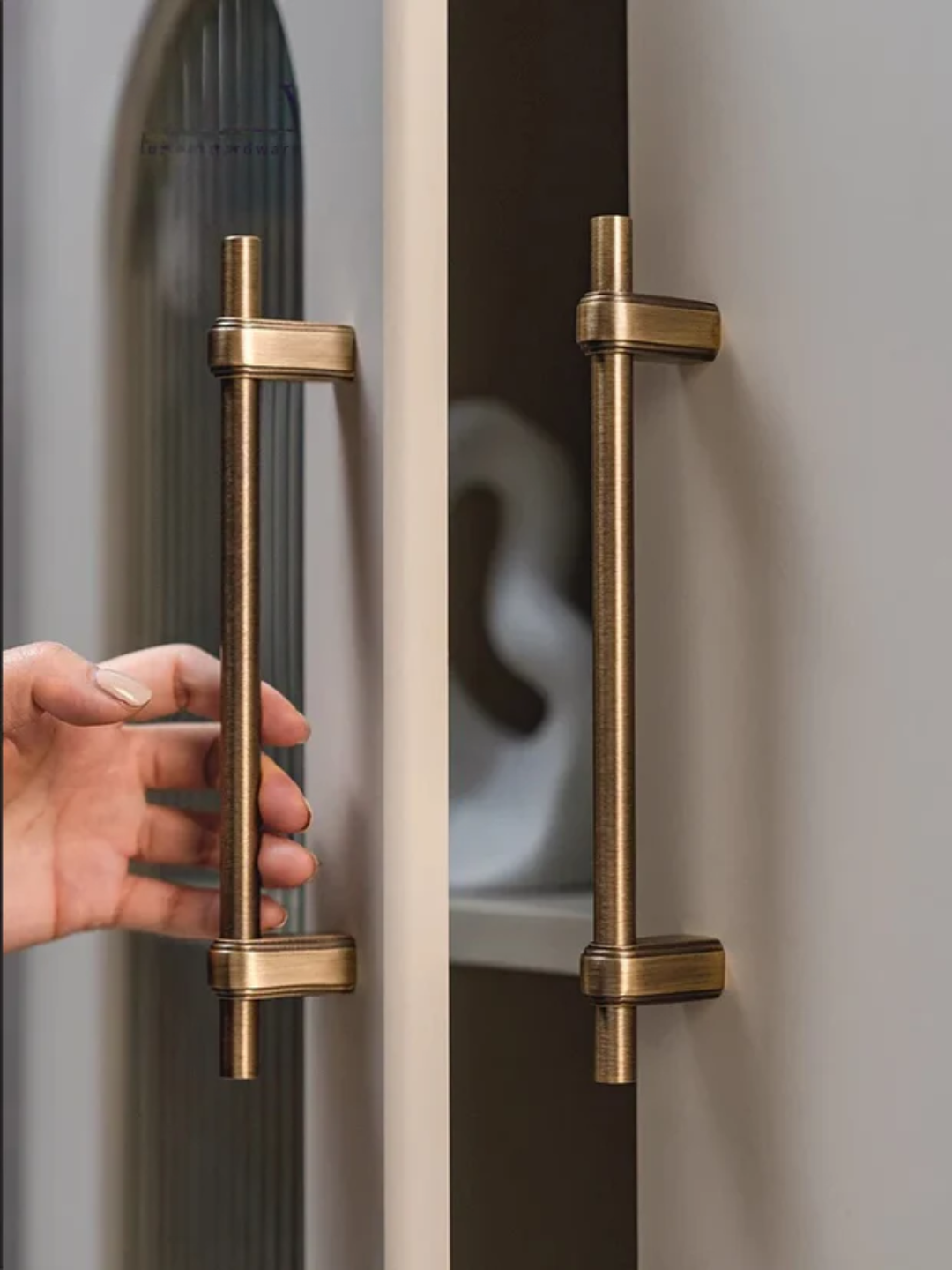 Close-up of a door handle with a hand opening a door, featuring the Santaya brand.