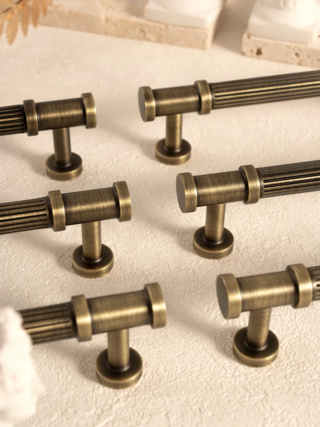 Set of bronze cabinet handles on a light background