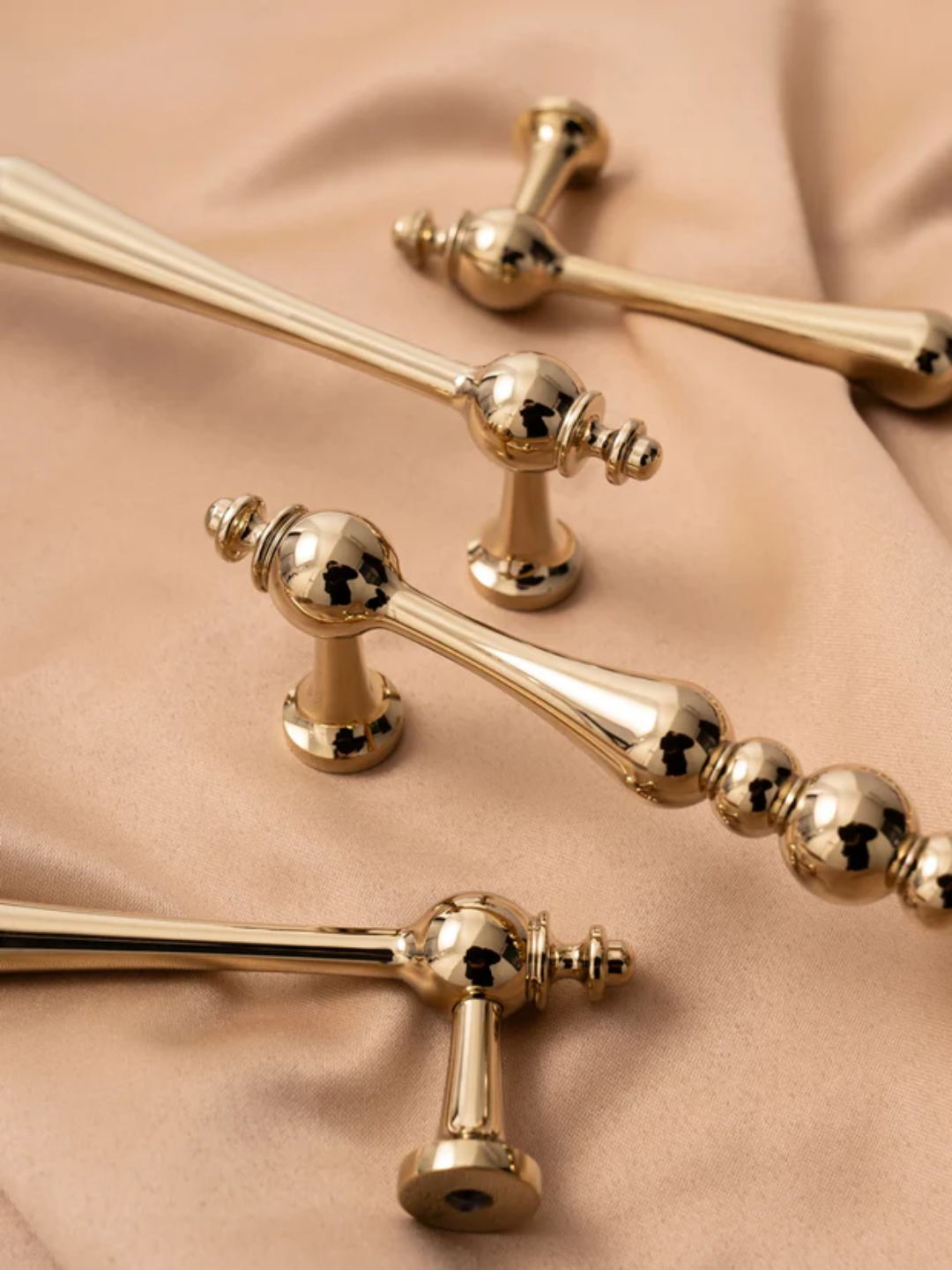 Gold decorative elements on a beige fabric background
