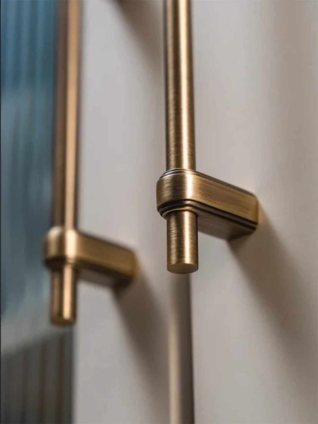 Close-up of a gold door handle on a glass door