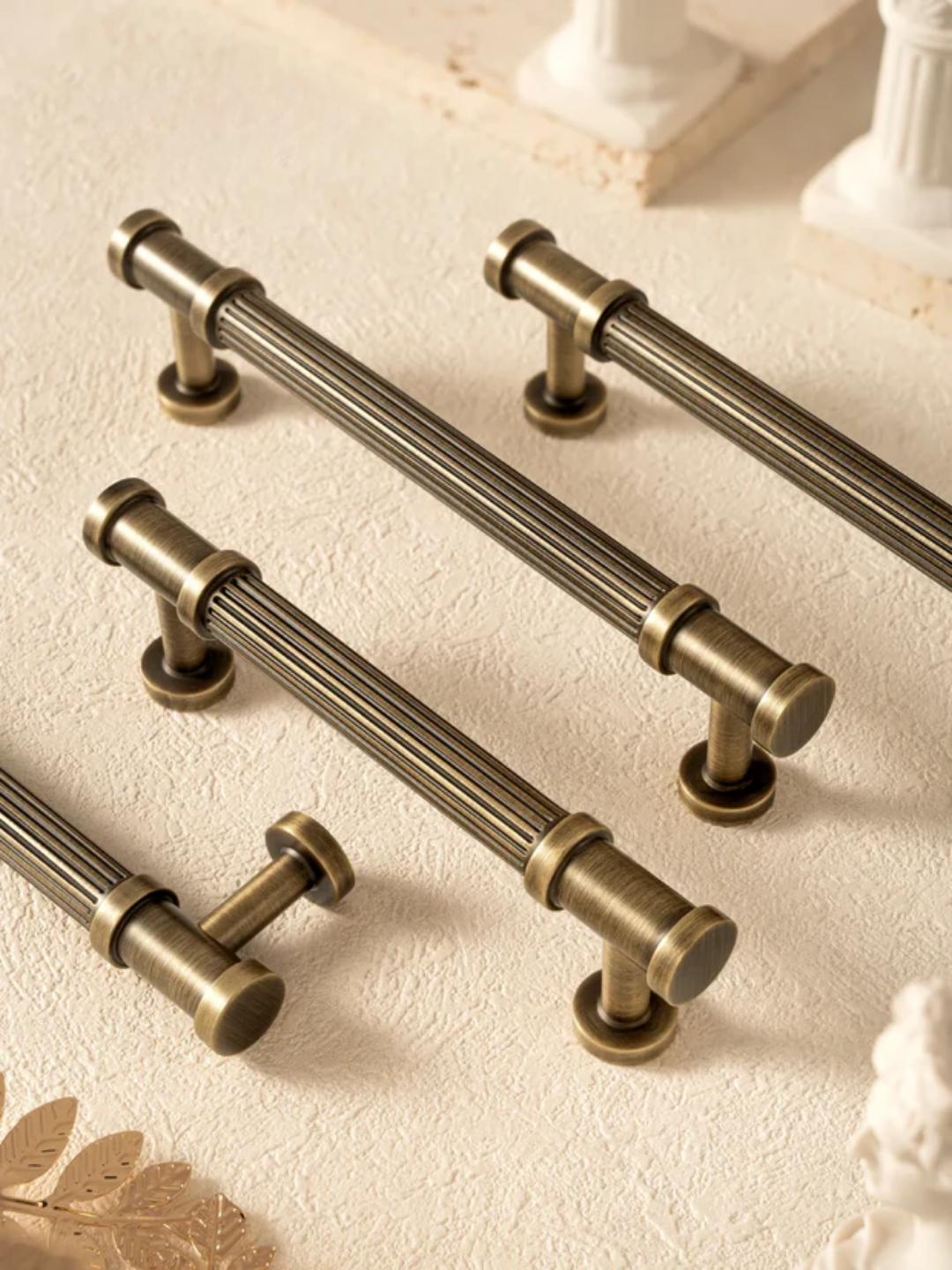 Set of bronze cabinet handles on a light background
