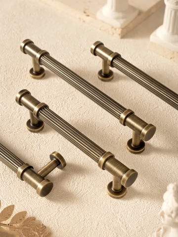 Set of bronze cabinet handles on a light background