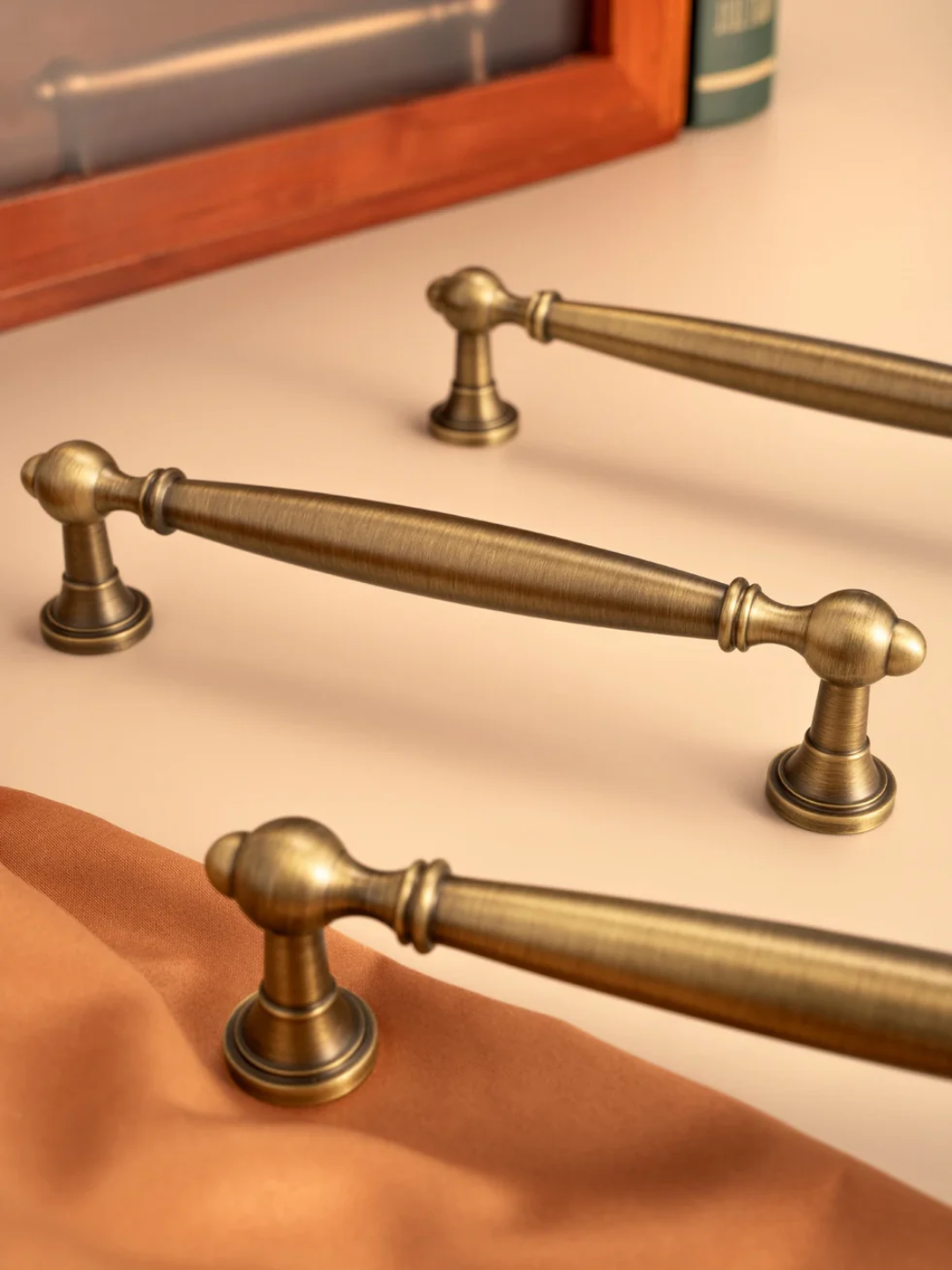 Brass cabinet handles on a neutral background