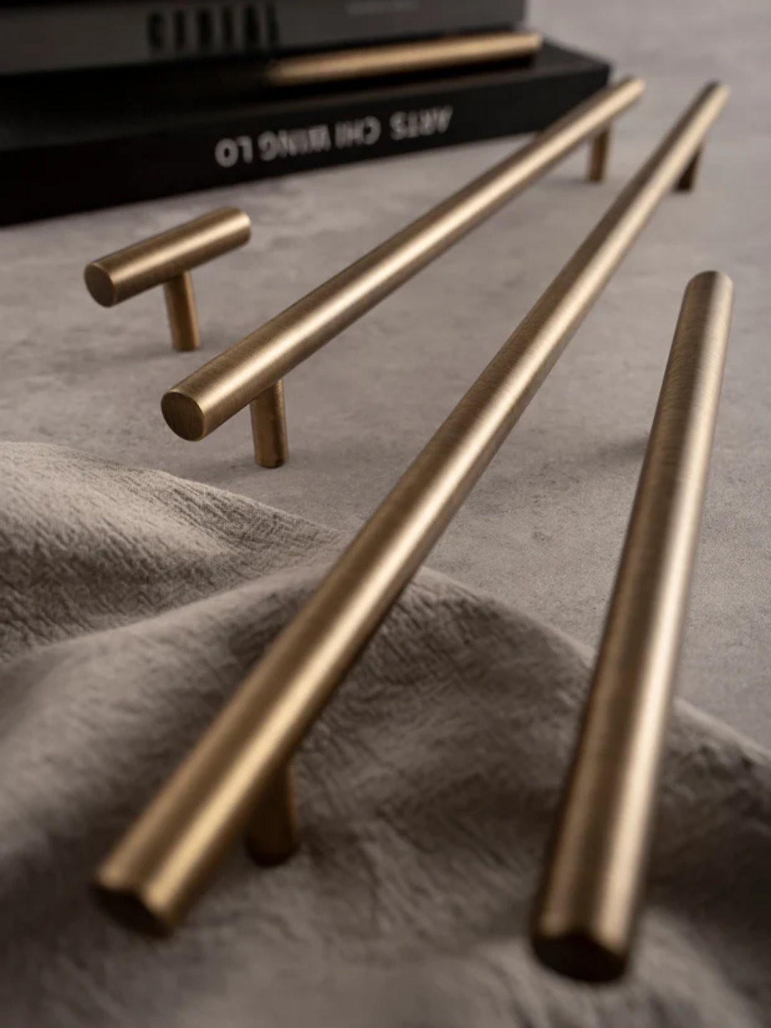 Gold cabinet handles on a textured surface