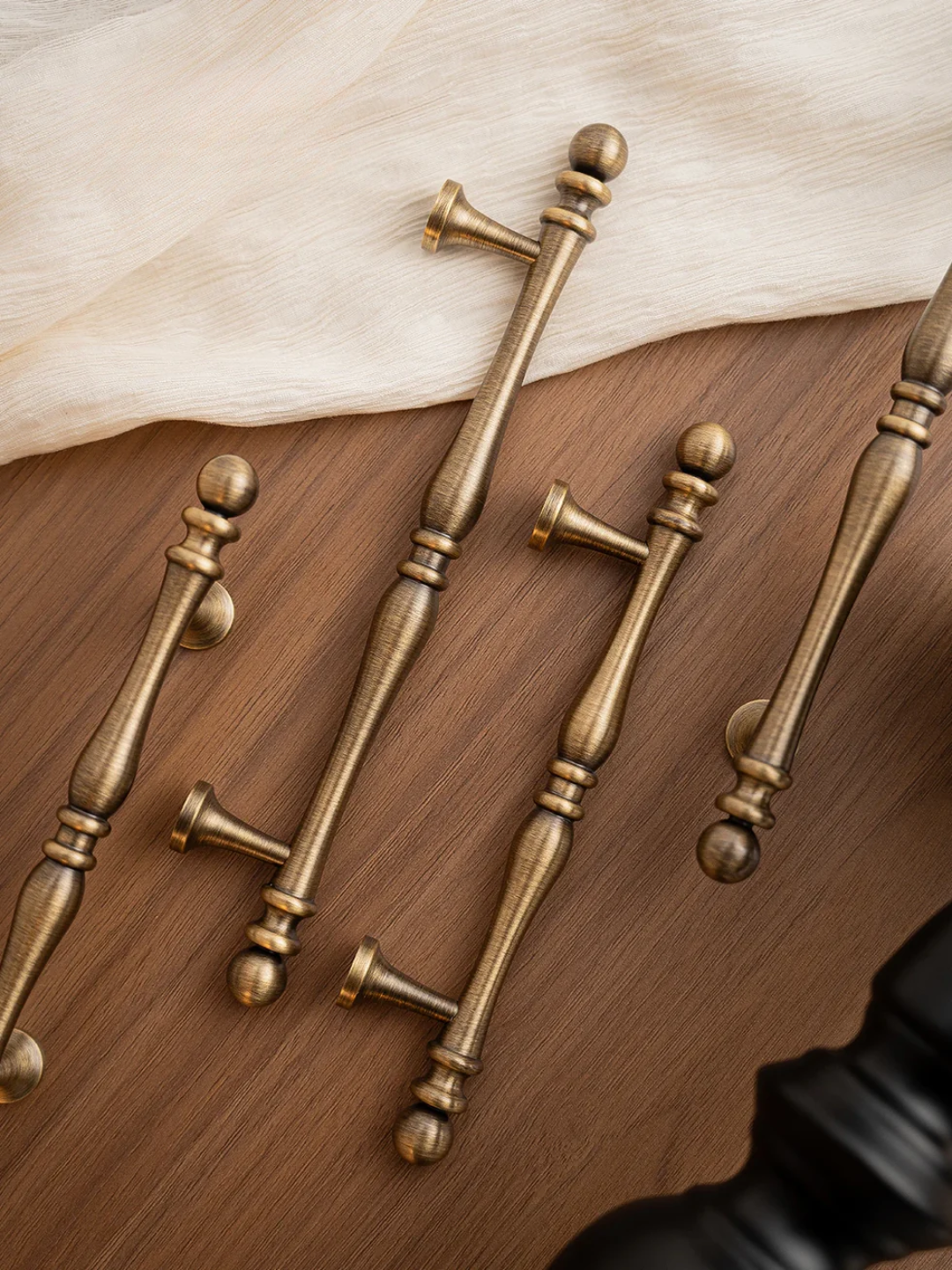 Set of bronze cabinet handles on a wooden surface