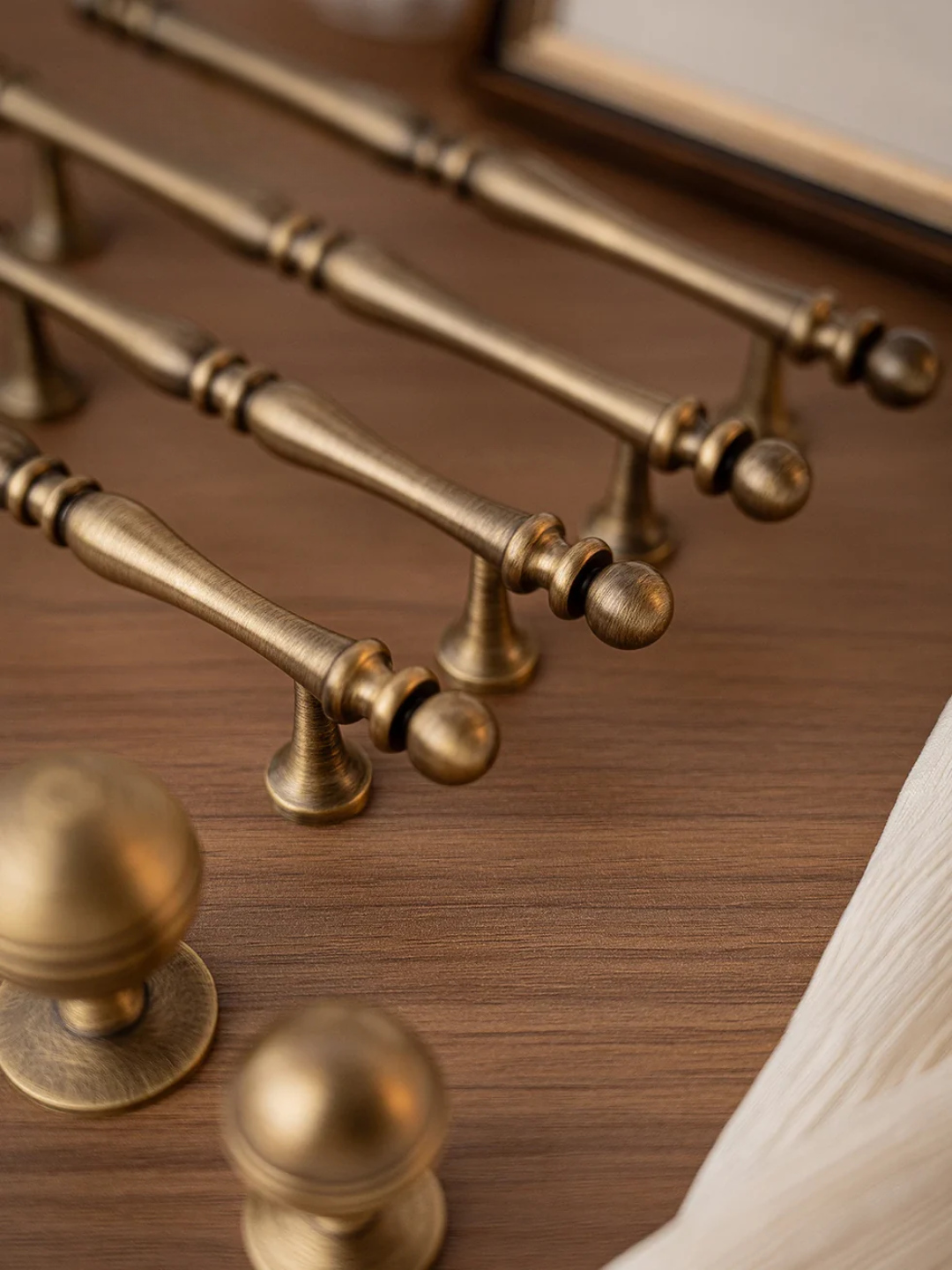 Collection of gold cabinet handles on a wooden surface with 'Santaya' branding.