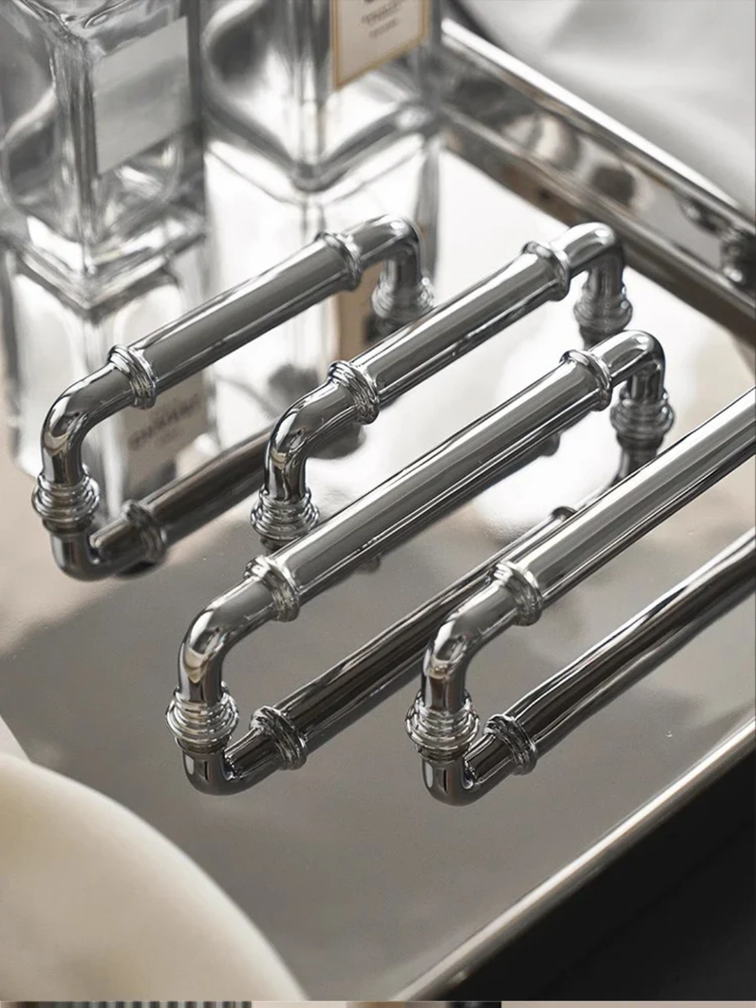 Set of silver cabinet handles on a white surface