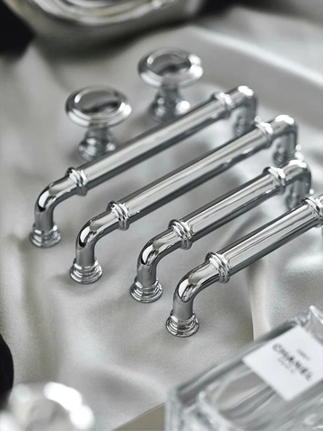 Set of silver cabinet handles on a white surface