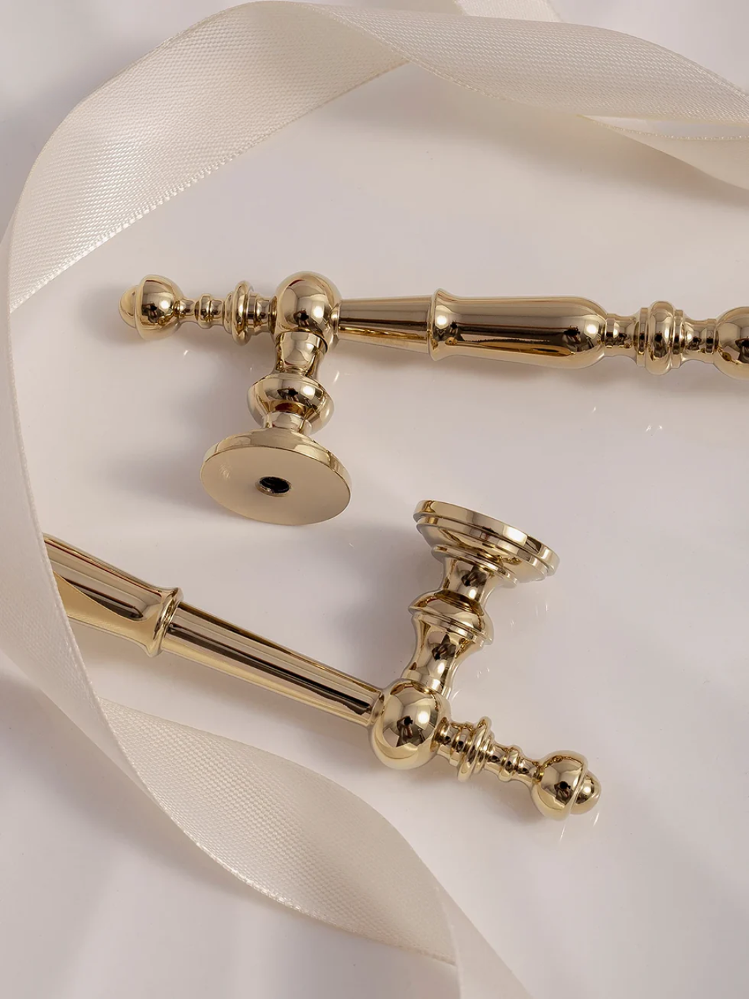 Gold decorative elements on a white fabric background