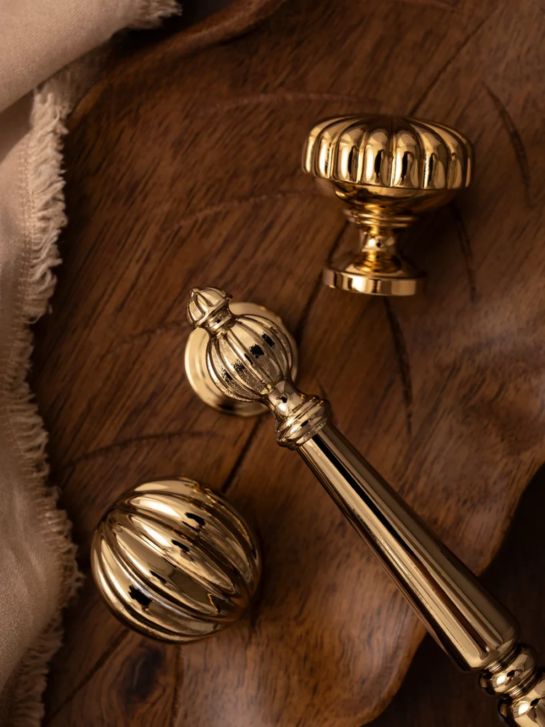 Gold door handles on a wooden surface