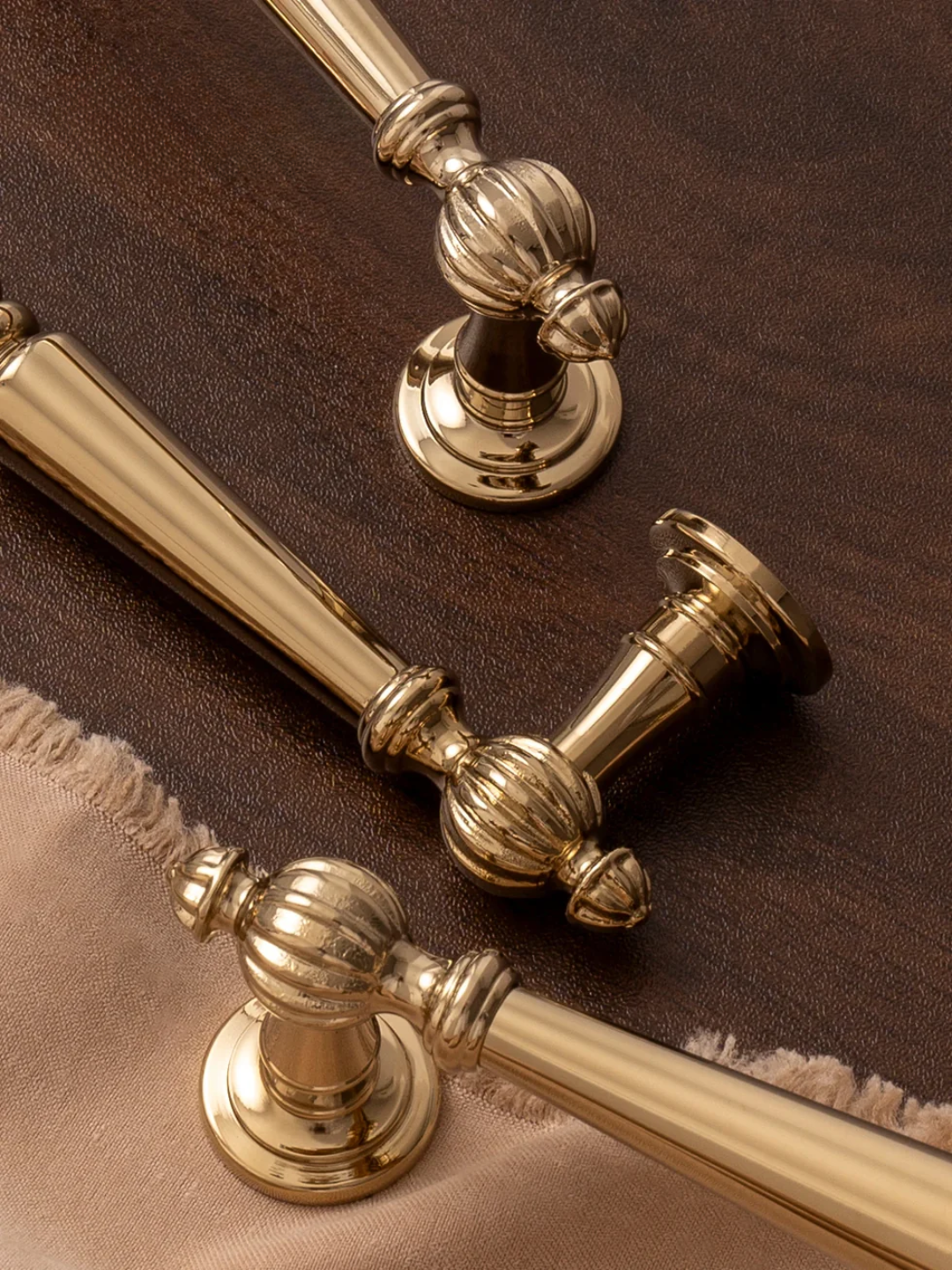 Gold decorative hardware pieces on a brown surface