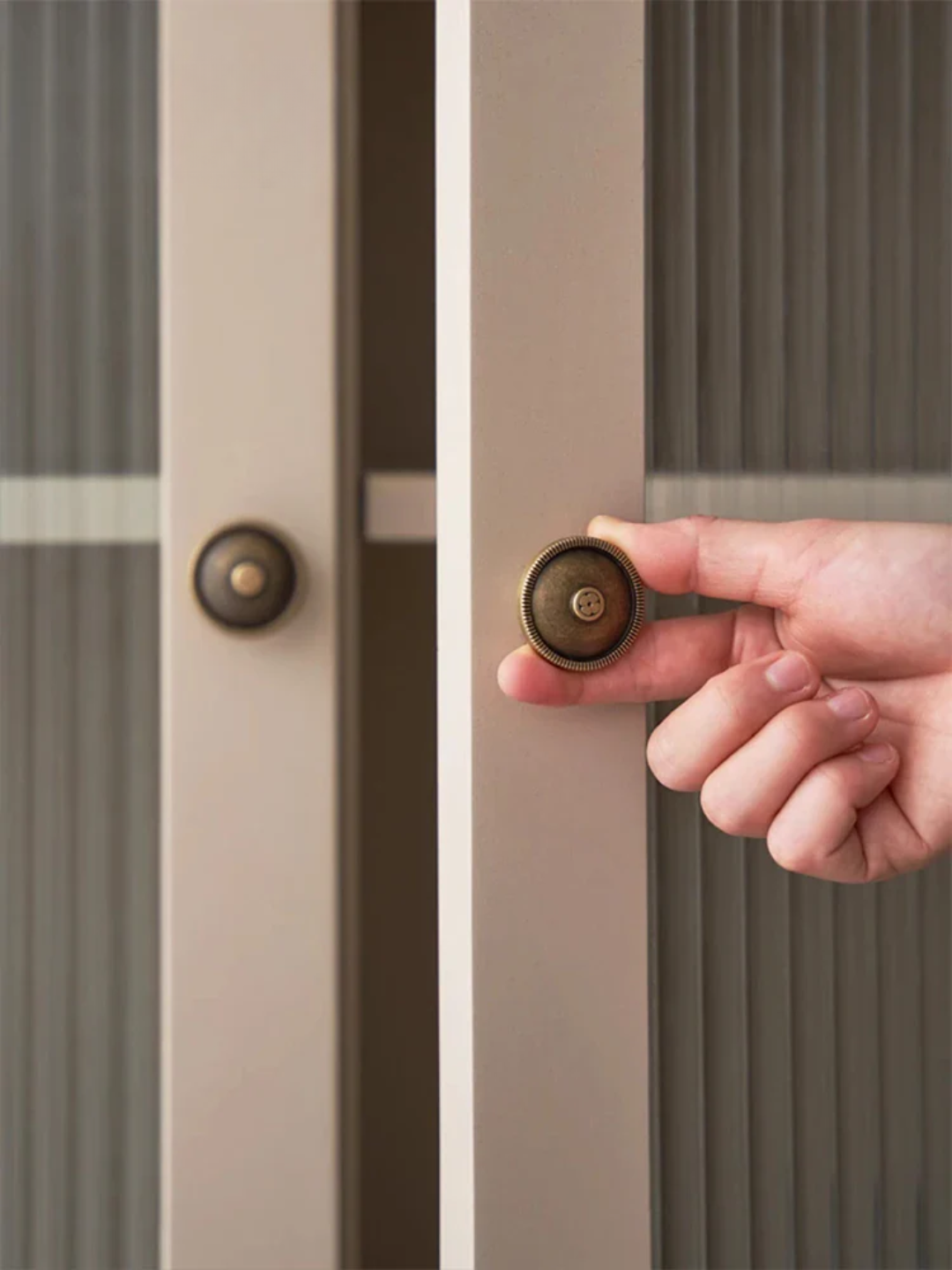 Hand opening a door with a doorknob