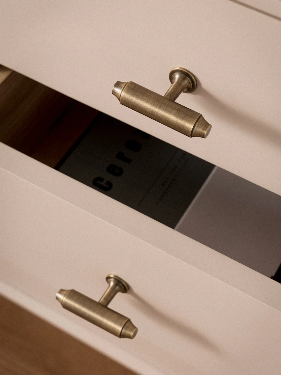 Close-up of a beige cabinet with metallic handles