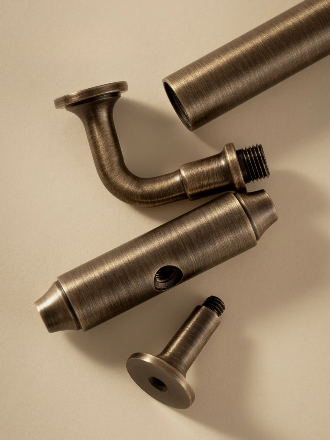 Bronze plumbing fixtures on a beige background