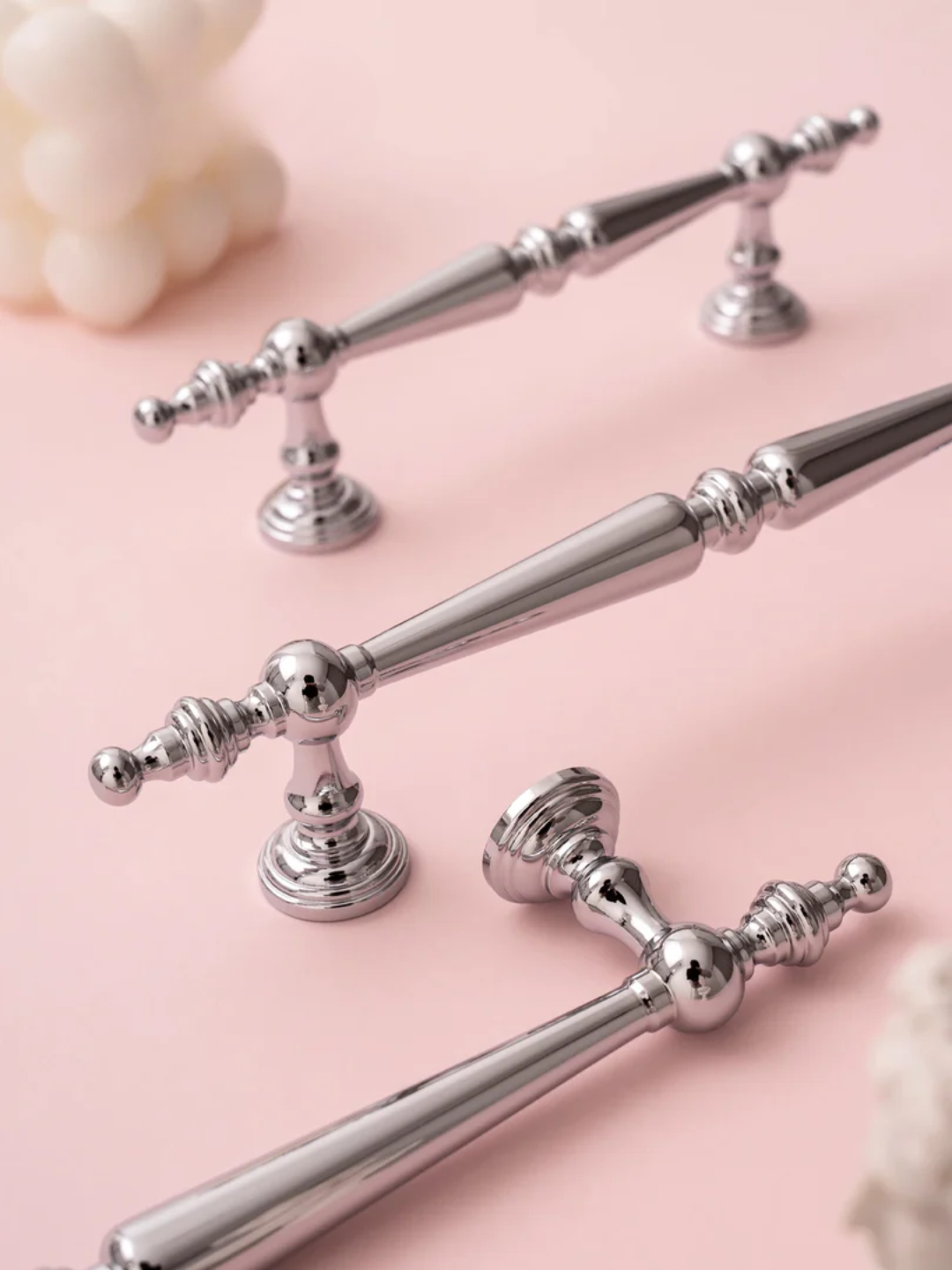 Silver handles on a pink background