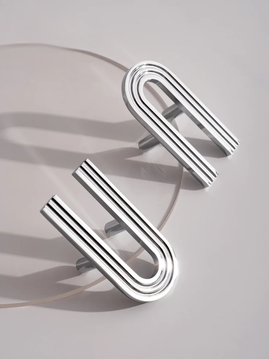 Silver U-shaped earrings on a light gray background