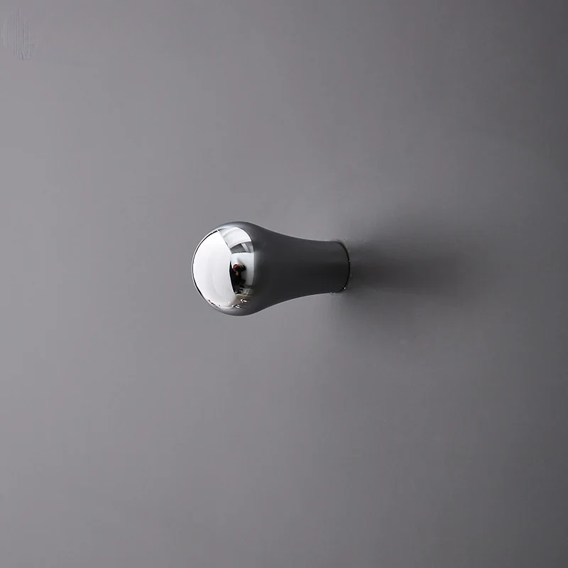 Metallic knob on a gray wall