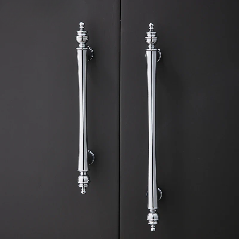 Pair of silver door handles on a black door