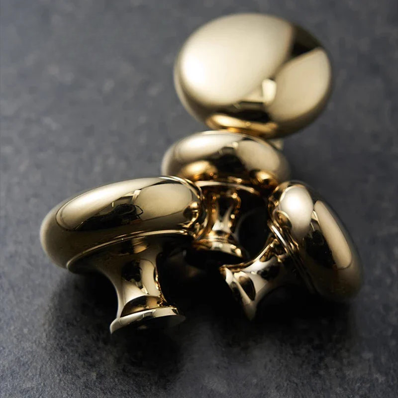 Gold metallic object on a dark gray background