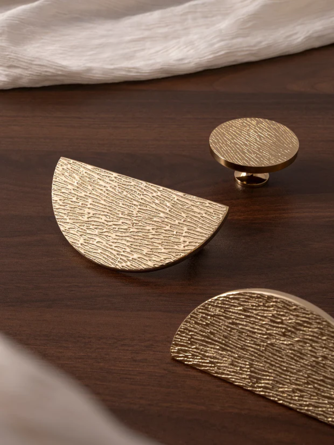 Gold Knobs on a wooden surface