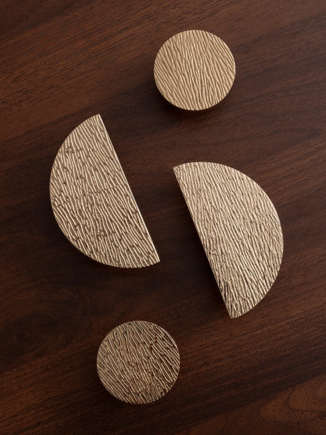 Wooden coasters of different shapes on a wooden surface