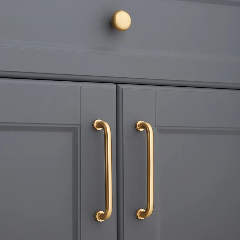 Gray cabinet with gold handles and knobs