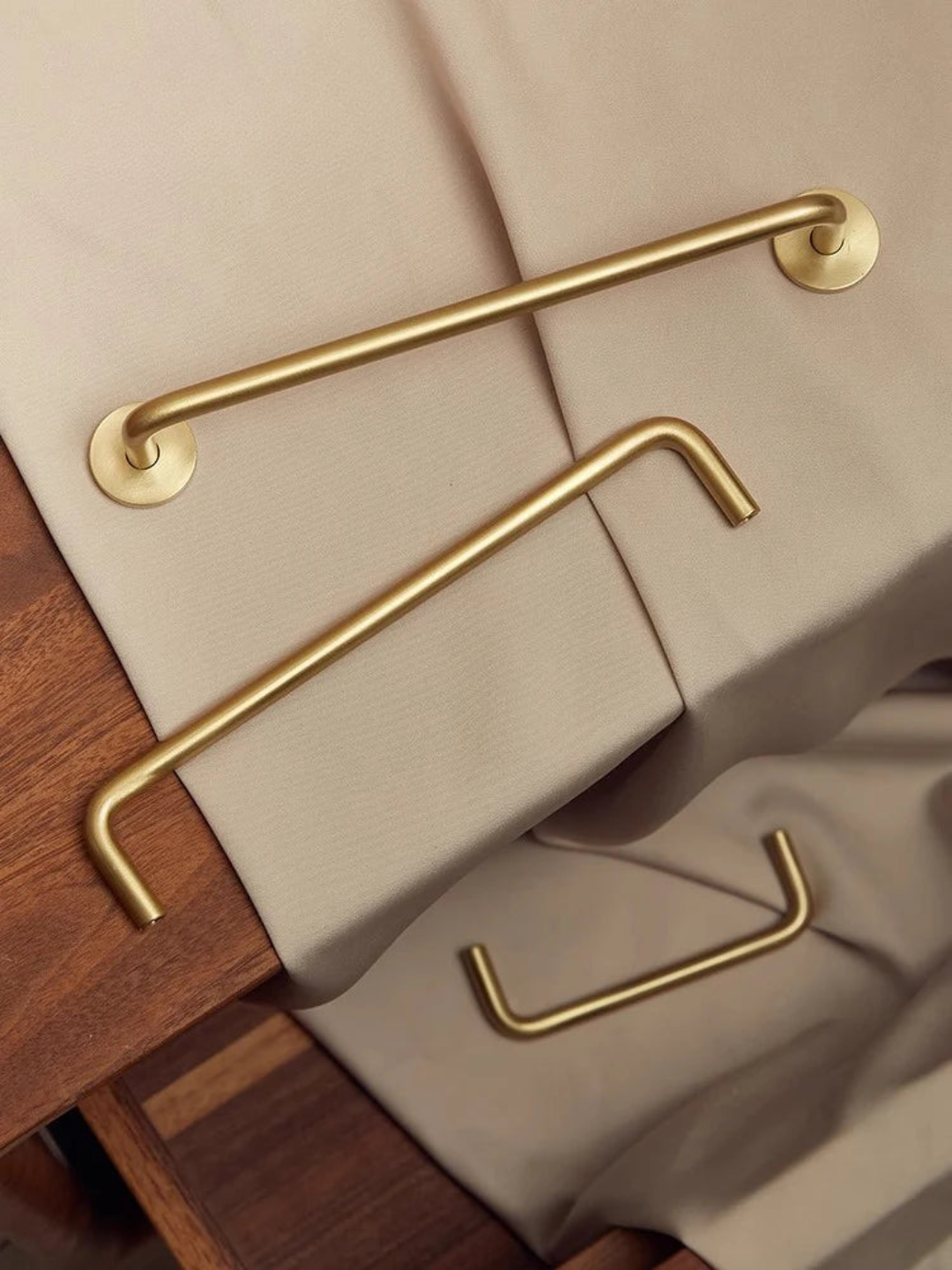 Gold handle on a beige surface with a wooden base