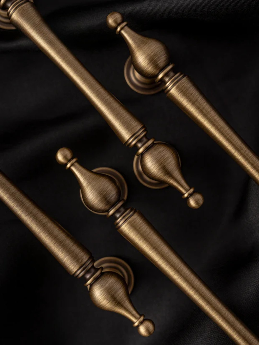 Decorative bronze finials on a black background