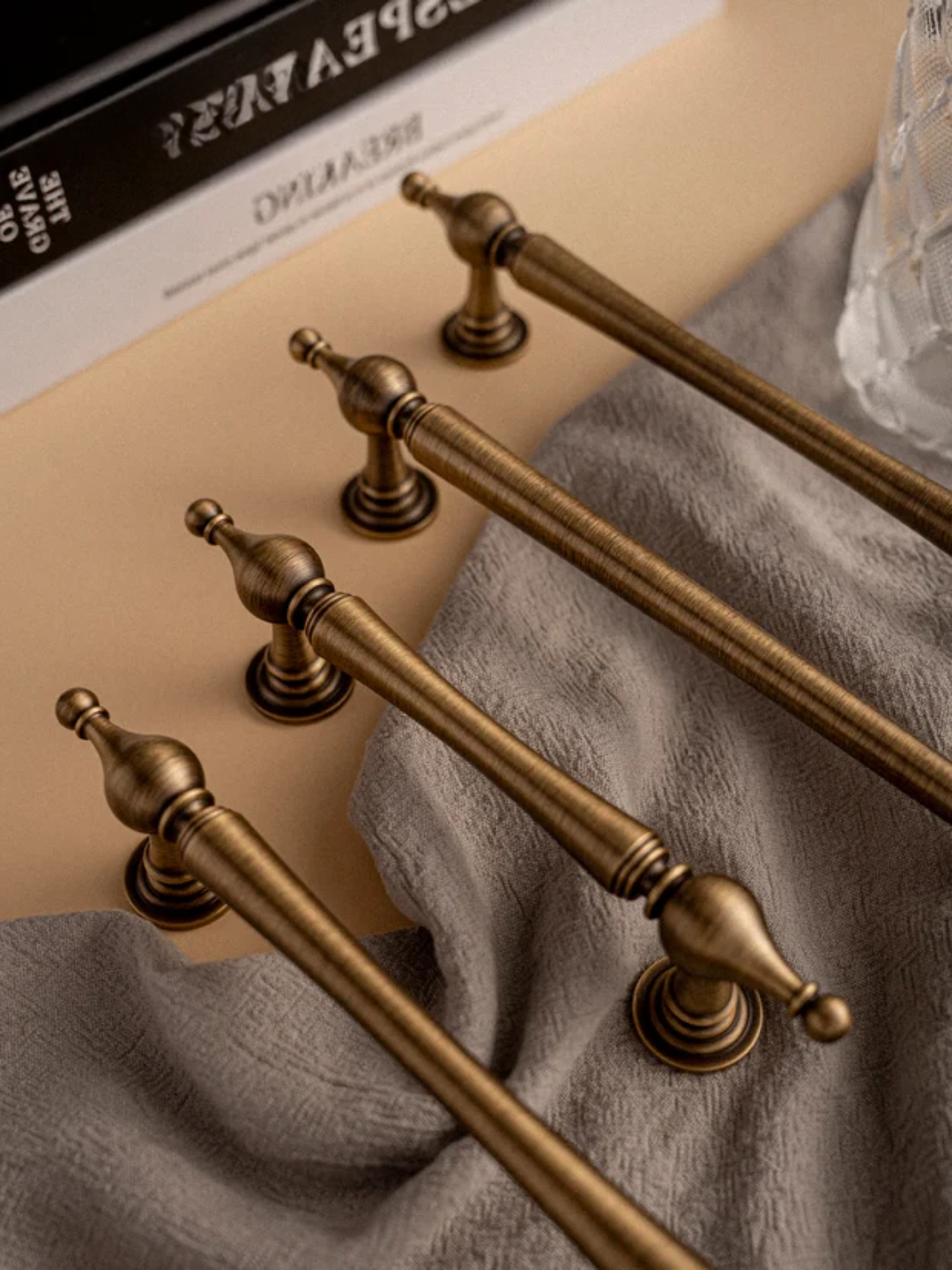 Set of gold handles on a textured surface.