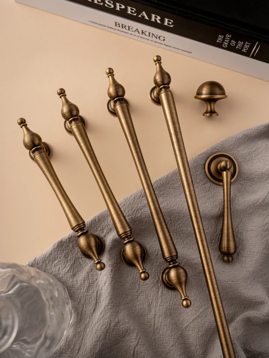 Set of gold handles on a textured surface.