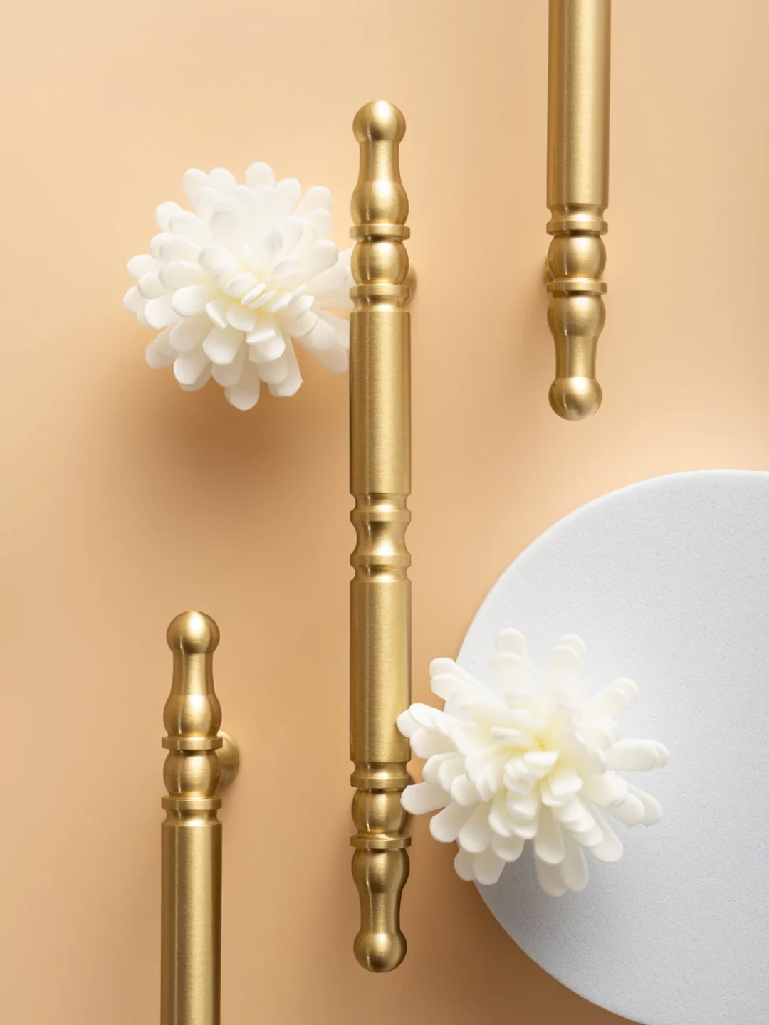 Gold decorative elements with white flowers on a beige background