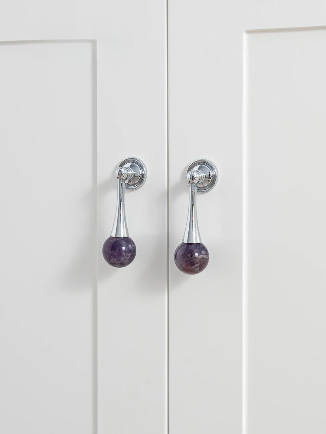 White cabinet doors with purple and silver handles
