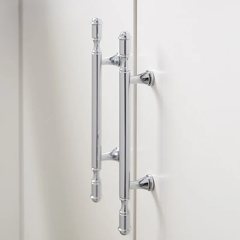 Chrome door handle on a white door