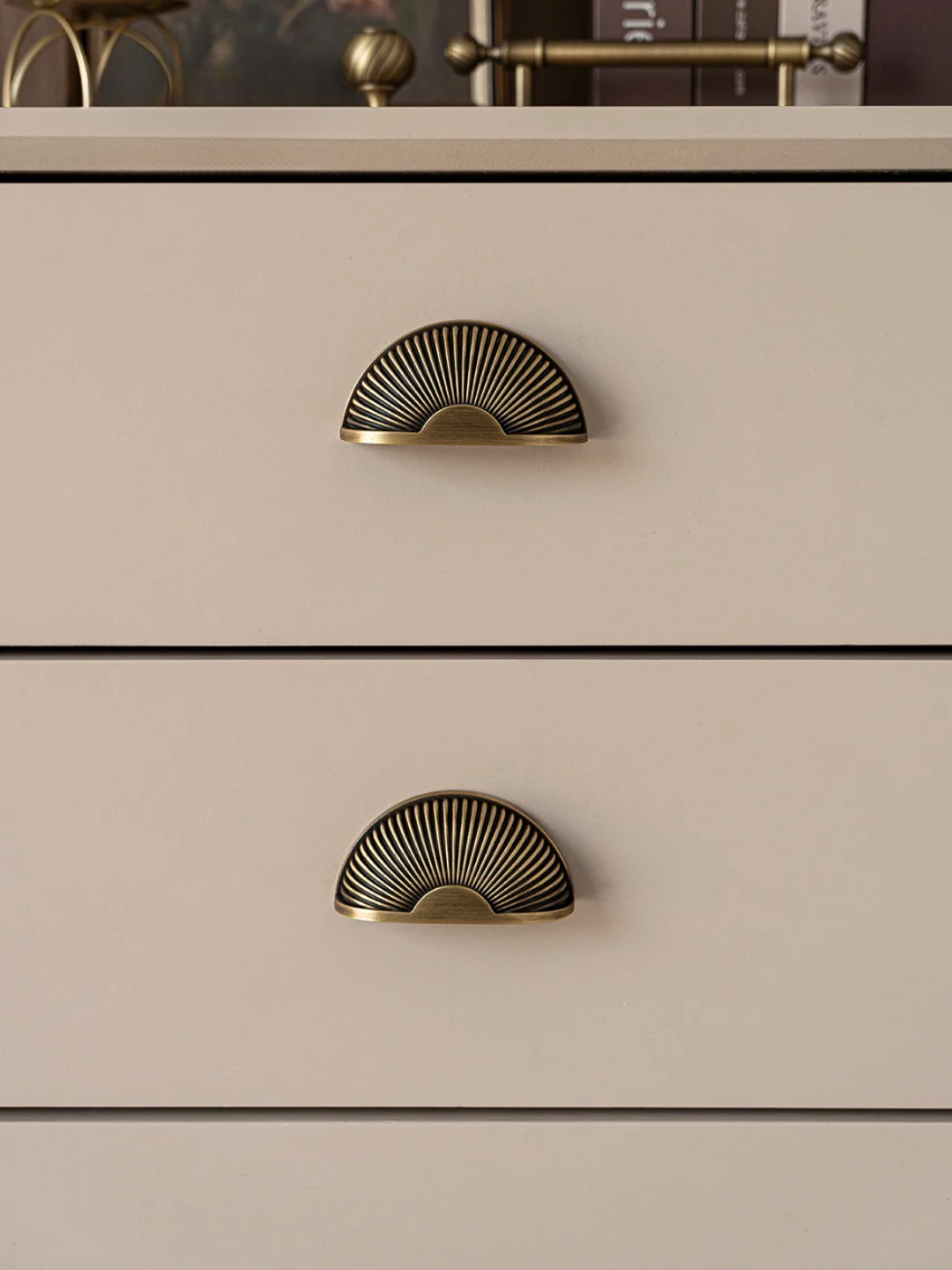Beige dresser with gold fan-shaped handles